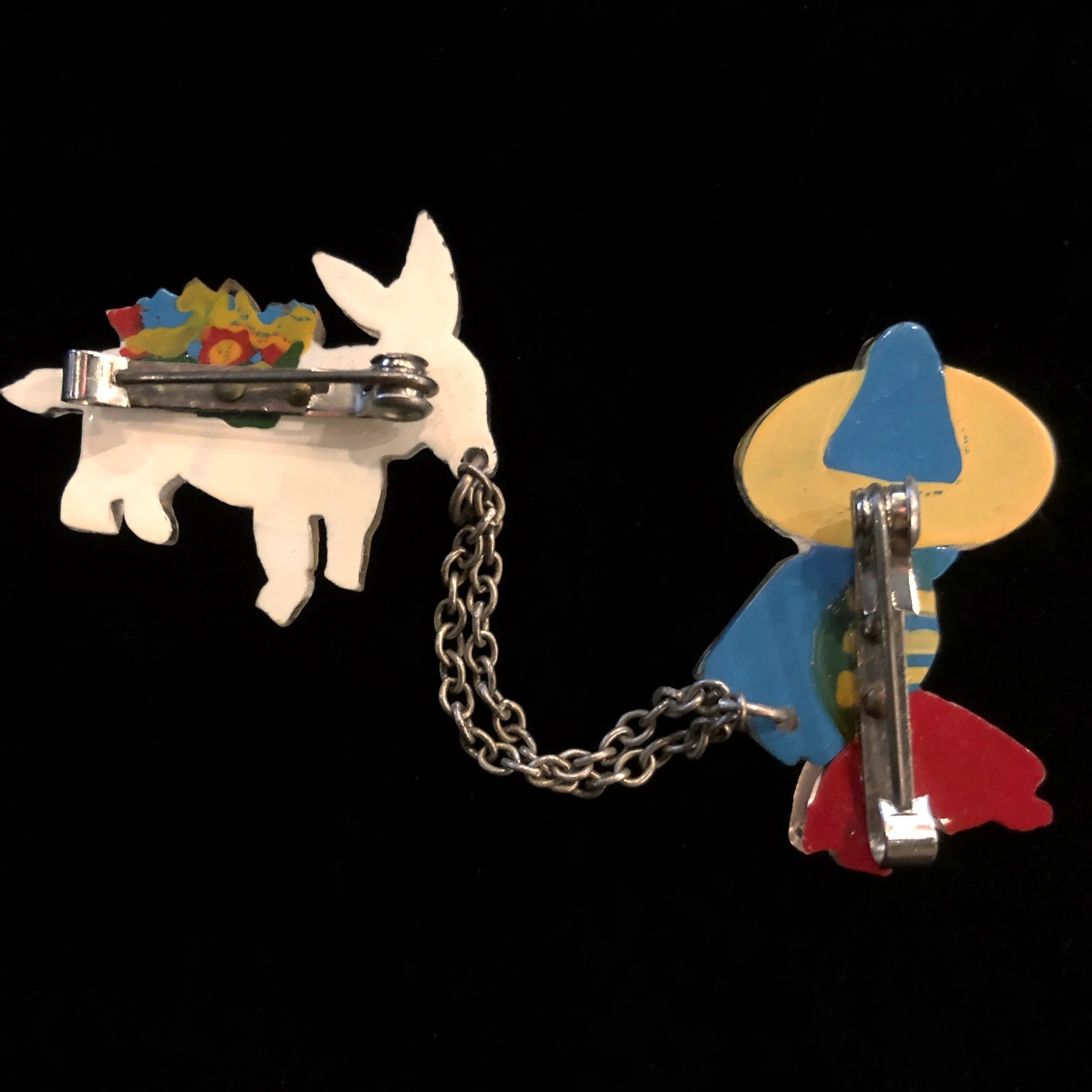 A 1940s VINTAGE LUCITE MEXICAN AND MULE BROOCH
