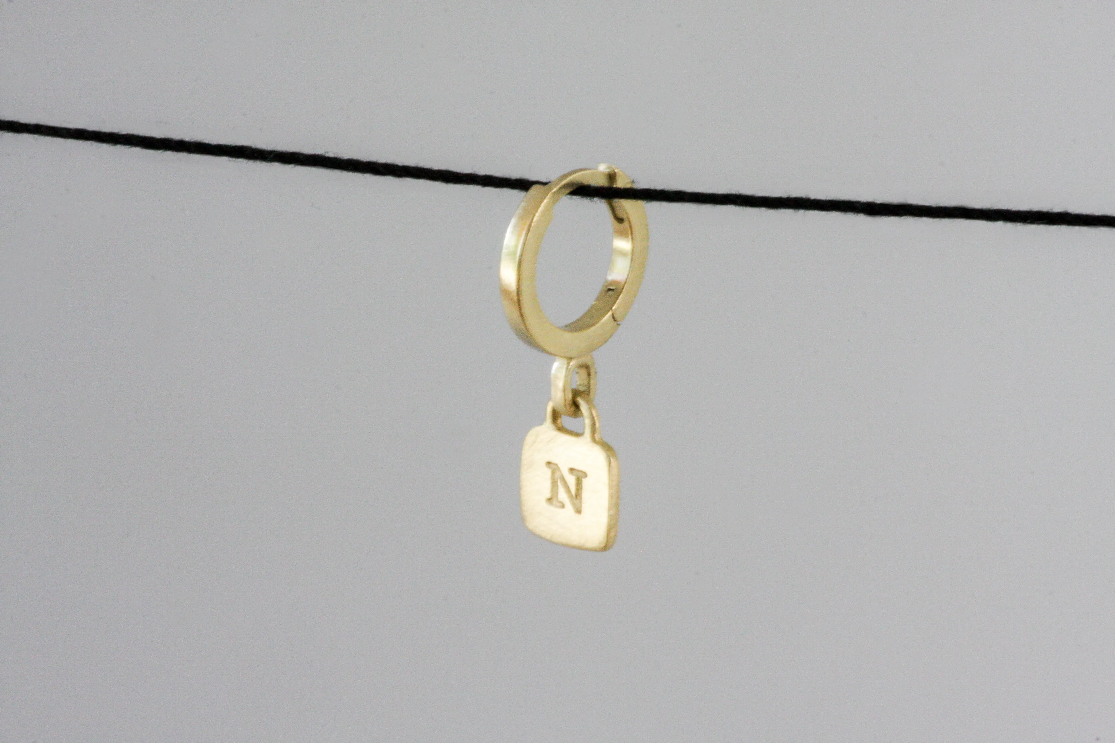 Gold Huggie with engraved letter